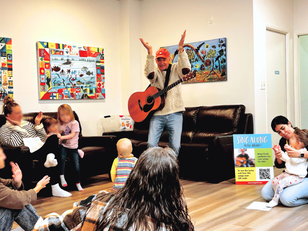 Children's musician, Brian Cook, offers a surprise performance at Circle Time.